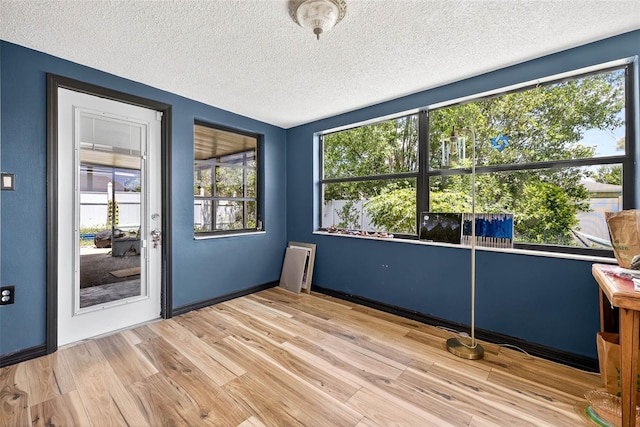 7814 Burnham Dr, Port Richey, FL 34668 - unfurnished office with a textured ceiling and wood finished floors