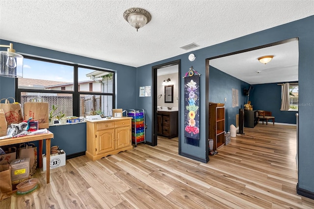 7814 Burnham Dr, Port Richey, FL 34668 - rec room with light wood-style flooring and a textured ceiling