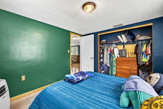 7814 Burnham Dr, Port Richey, FL 34668 - tiled bedroom featuring a closet and a textured ceiling