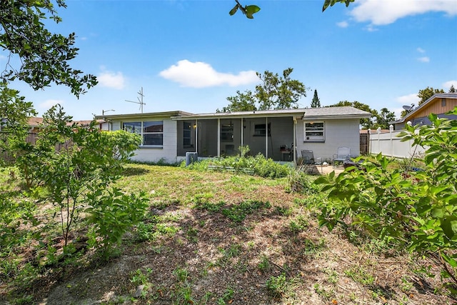 7814 Burnham Dr, Port Richey, FL 34668 - rear view of house featuring a sunroom