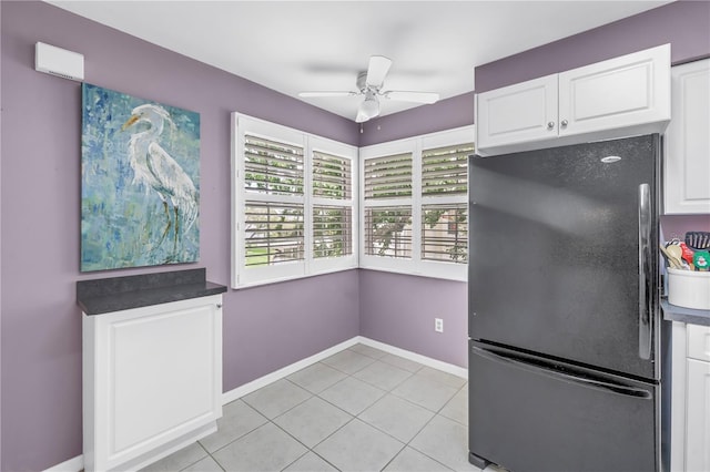 6916 Stones Throw Cir N Unit 9207, Saint Petersburg, FL 33710 - kitchen featuring freestanding refrigerator, a ceiling fan, white cabinets, light tile patterned flooring, and dark countertops