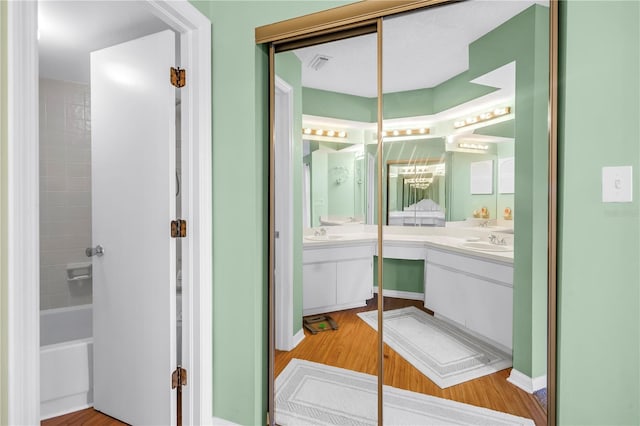 6916 Stones Throw Cir N Unit 9207, Saint Petersburg, FL 33710 - bathroom with vanity, wood finished floors, and shower / washtub combination
