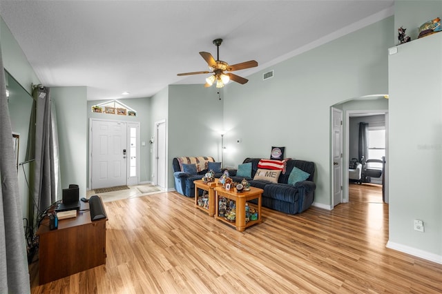 5112 Prairie View Way, Wesley Chapel, FL 33545 - living room with lofted ceiling, ceiling fan, light wood-type flooring, arched walkways, and an office area