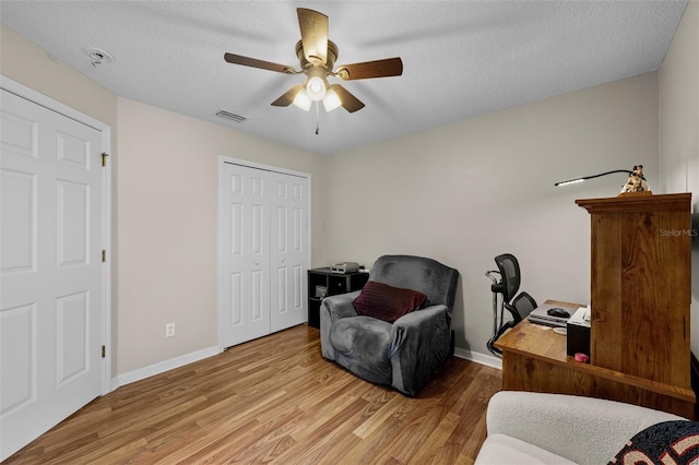 5112 Prairie View Way, Wesley Chapel, FL 33545 - living area featuring wood finished floors, a ceiling fan, a textured ceiling, and a desk