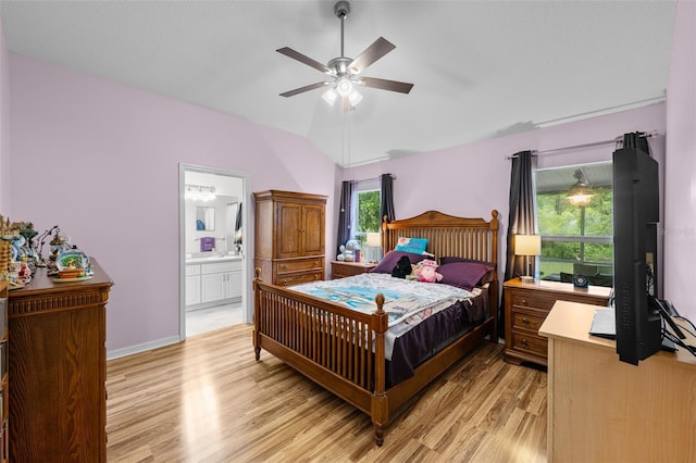 5112 Prairie View Way, Wesley Chapel, FL 33545 - bedroom with light wood-style floors, vaulted ceiling, ensuite bathroom, and ceiling fan