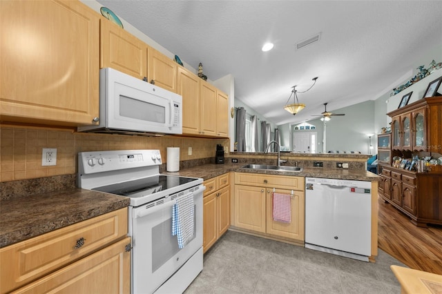 5112 Prairie View Way, Wesley Chapel, FL 33545 - kitchen featuring white appliances, vaulted ceiling, light brown cabinets, a peninsula, and dark countertops