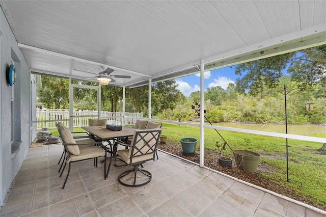 5112 Prairie View Way, Wesley Chapel, FL 33545 - sunroom featuring outdoor dining space, a ceiling fan, and view of wooded area
