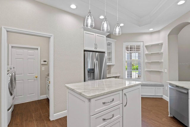 27455 Mistflower Dr, Wesley Chapel, FL 33544 - kitchen with stainless steel appliances, independent washer and dryer, white cabinetry, ornamental molding, and glass insert cabinets