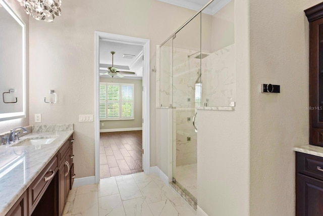 27455 Mistflower Dr, Wesley Chapel, FL 33544 - bathroom with marble finish floors, vanity, a marble finish shower, ceiling fan, and crown molding