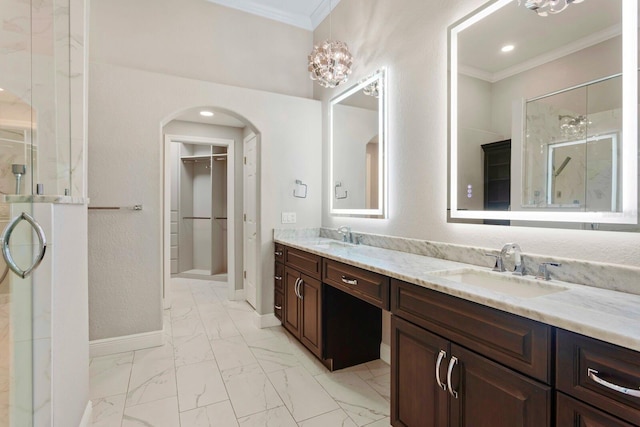 27455 Mistflower Dr, Wesley Chapel, FL 33544 - bathroom with marble finish floors, ornamental molding, double vanity, a shower stall, and a walk in closet
