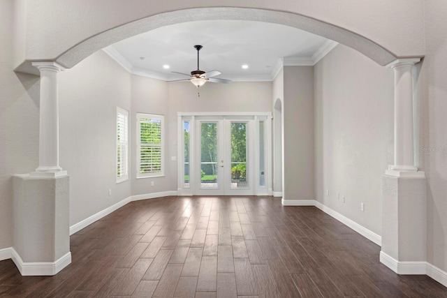 27455 Mistflower Dr, Wesley Chapel, FL 33544 - unfurnished living room featuring a ceiling fan, dark wood-style flooring, recessed lighting, ornamental molding, and decorative columns