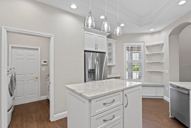 27455 Mistflower Dr, Wesley Chapel, FL 33544 - kitchen with stainless steel appliances, washer and dryer, crown molding, white cabinetry, and glass insert cabinets