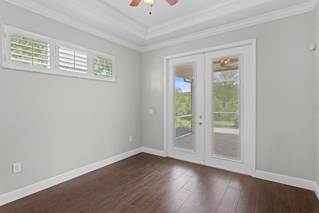 27455 Mistflower Dr, Wesley Chapel, FL 33544 - empty room with french doors, a ceiling fan, dark wood-style floors, a tray ceiling, and ornamental molding