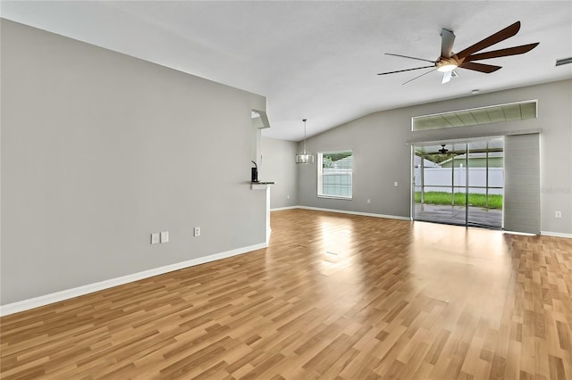 19635 Bellehurst Loop, Land O Lakes, FL 34638 - unfurnished living room featuring vaulted ceiling, light wood finished floors, and ceiling fan