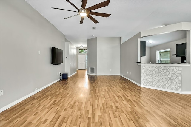 19635 Bellehurst Loop, Land O Lakes, FL 34638 - unfurnished living room with light wood finished floors, healthy amount of natural light, and ceiling fan