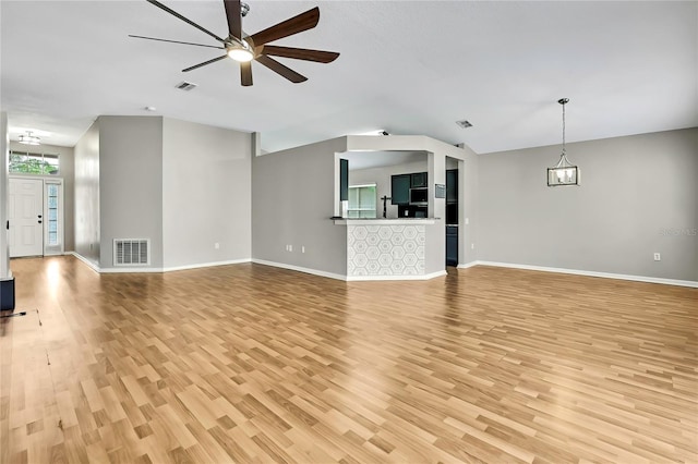 19635 Bellehurst Loop, Land O Lakes, FL 34638 - unfurnished living room with light wood-style flooring and a ceiling fan