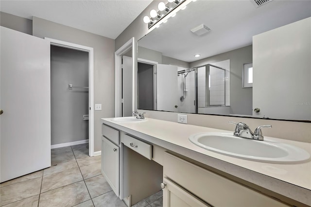 19635 Bellehurst Loop, Land O Lakes, FL 34638 - bathroom with double vanity, a shower stall, and tile patterned flooring