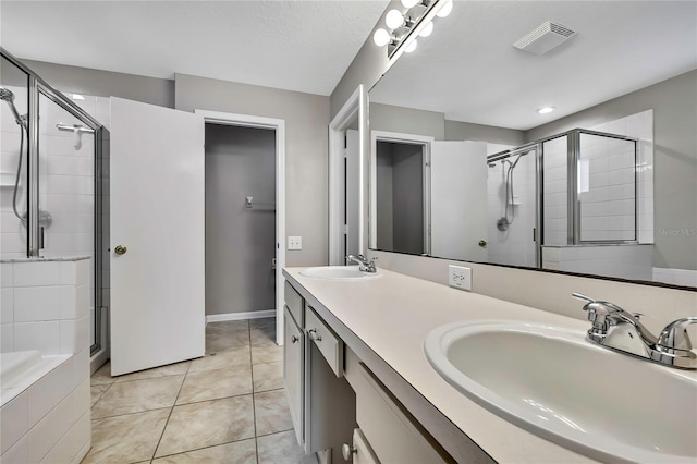 19635 Bellehurst Loop, Land O Lakes, FL 34638 - full bathroom with a shower stall, double vanity, and tile patterned floors