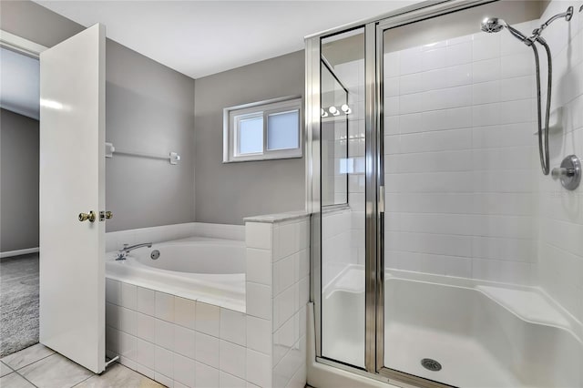 19635 Bellehurst Loop, Land O Lakes, FL 34638 - bathroom with a shower stall, a bath, and tile patterned flooring