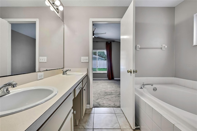 19635 Bellehurst Loop, Land O Lakes, FL 34638 - full bathroom featuring double vanity, tile patterned floors, a bath, and vaulted ceiling