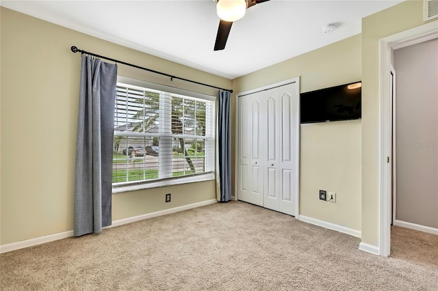 19635 Bellehurst Loop, Land O Lakes, FL 34638 - unfurnished bedroom featuring carpet, a closet, and a ceiling fan