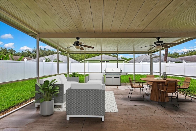 19635 Bellehurst Loop, Land O Lakes, FL 34638 - fenced backyard with a ceiling fan, an outdoor hangout area, outdoor dining space, and a patio