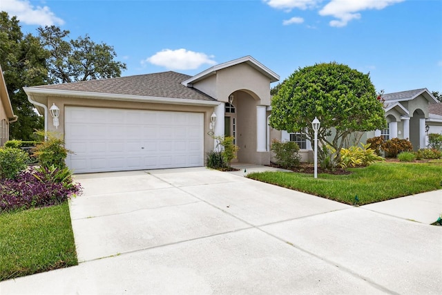 11348 Tee Time Cir, New Port Richey, FL 34654 - view of front of house featuring stucco siding, a garage, and concrete driveway