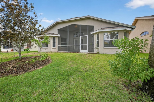 11348 Tee Time Cir, New Port Richey, FL 34654 - back of property featuring a sunroom, a lawn, and stucco siding