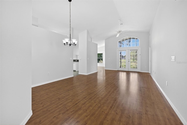 11348 Tee Time Cir, New Port Richey, FL 34654 - unfurnished living room with ceiling fan, a chandelier, dark wood-style flooring, and high vaulted ceiling
