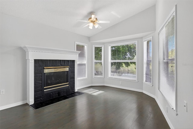 11348 Tee Time Cir, New Port Richey, FL 34654 - unfurnished living room featuring ceiling fan, a fireplace, vaulted ceiling, plenty of natural light, and dark wood finished floors