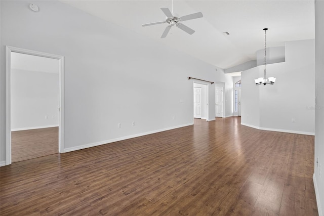 11348 Tee Time Cir, New Port Richey, FL 34654 - unfurnished living room featuring vaulted ceiling, dark wood finished floors, ceiling fan, and a chandelier