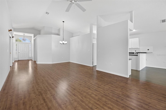 11348 Tee Time Cir, New Port Richey, FL 34654 - unfurnished living room featuring a chandelier, ceiling fan, lofted ceiling, and dark wood-type flooring