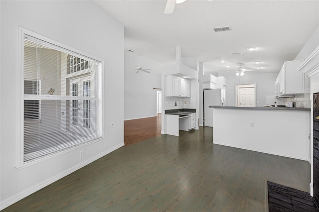11348 Tee Time Cir, New Port Richey, FL 34654 - kitchen with ceiling fan, freestanding refrigerator, lofted ceiling, dark countertops, and backsplash