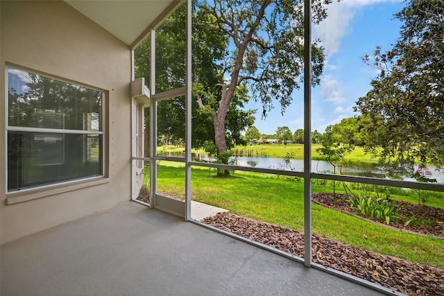 11348 Tee Time Cir, New Port Richey, FL 34654 - unfurnished sunroom featuring a water view, healthy amount of natural light, and vaulted ceiling