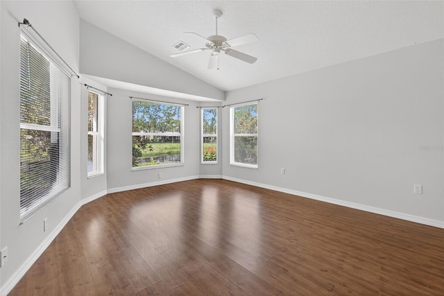 11348 Tee Time Cir, New Port Richey, FL 34654 - empty room featuring lofted ceiling, a ceiling fan, and wood finished floors
