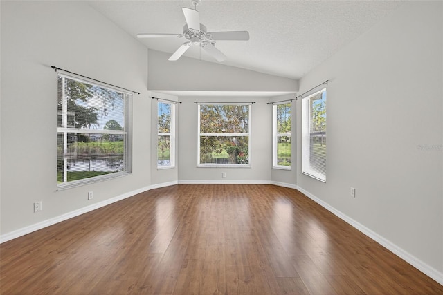 11348 Tee Time Cir, New Port Richey, FL 34654 - spare room featuring vaulted ceiling, wood finished floors, ceiling fan, and a textured ceiling