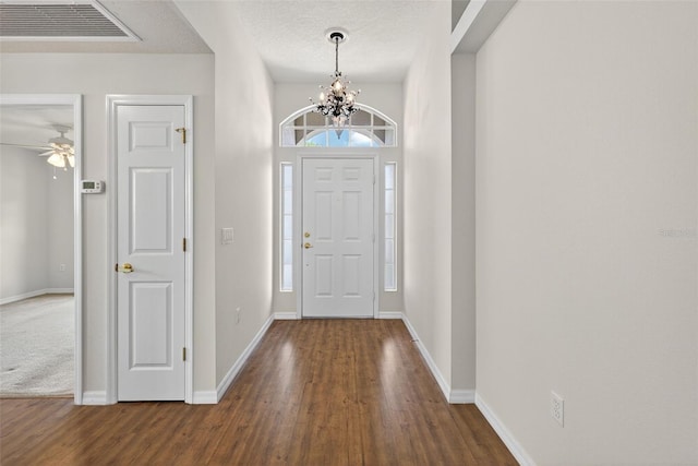 11348 Tee Time Cir, New Port Richey, FL 34654 - entrance foyer featuring wood finished floors, a chandelier, and a ceiling fan