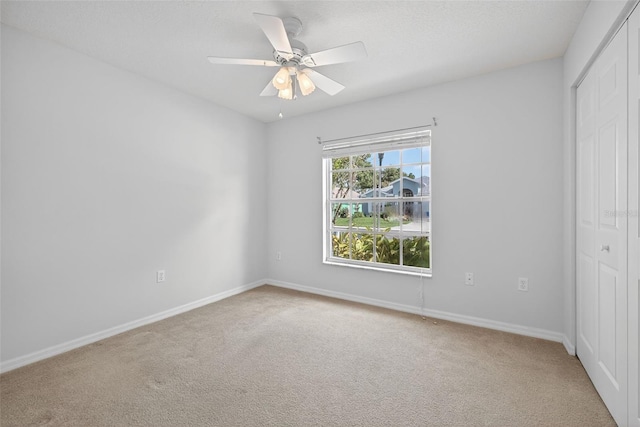 11348 Tee Time Cir, New Port Richey, FL 34654 - unfurnished bedroom with a closet, carpet flooring, and a ceiling fan