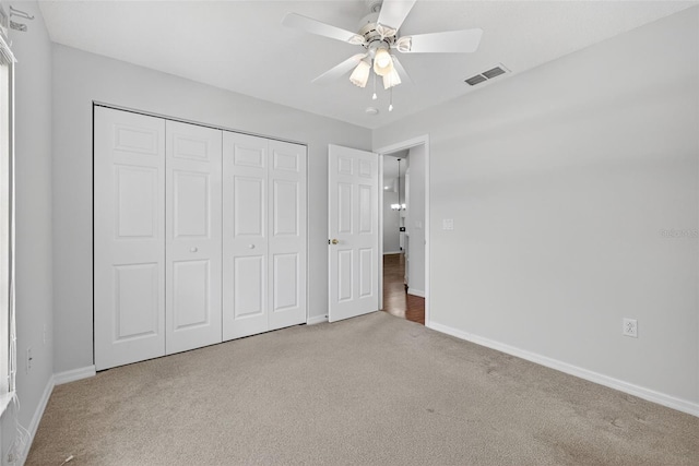 11348 Tee Time Cir, New Port Richey, FL 34654 - unfurnished bedroom featuring carpet, a closet, and a ceiling fan