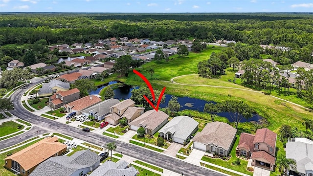11348 Tee Time Cir, New Port Richey, FL 34654 - aerial perspective of suburban area with a large body of water and a heavily wooded area