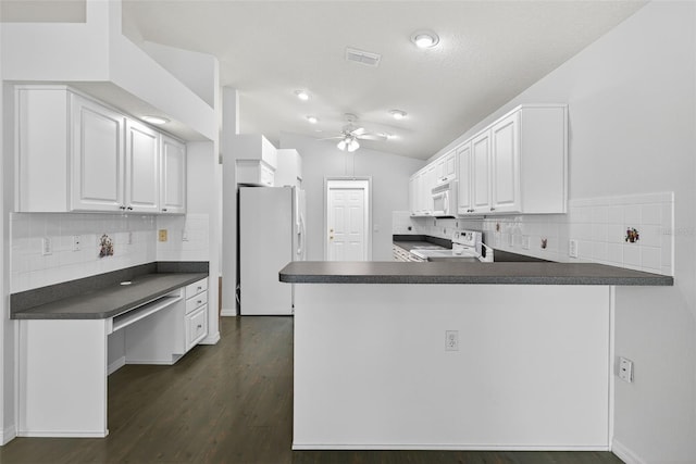 11348 Tee Time Cir, New Port Richey, FL 34654 - kitchen with white appliances, dark countertops, a ceiling fan, white cabinetry, and decorative backsplash