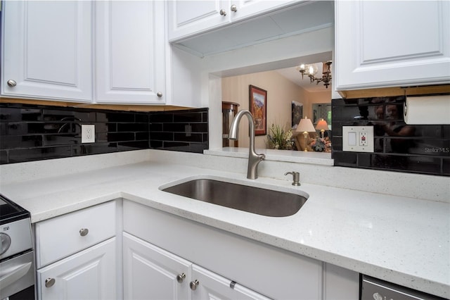 1701 Pinehurst Rd Unit 24B, Dunedin, FL 34698 - kitchen with tasteful backsplash, white cabinetry, a chandelier, and light stone counters