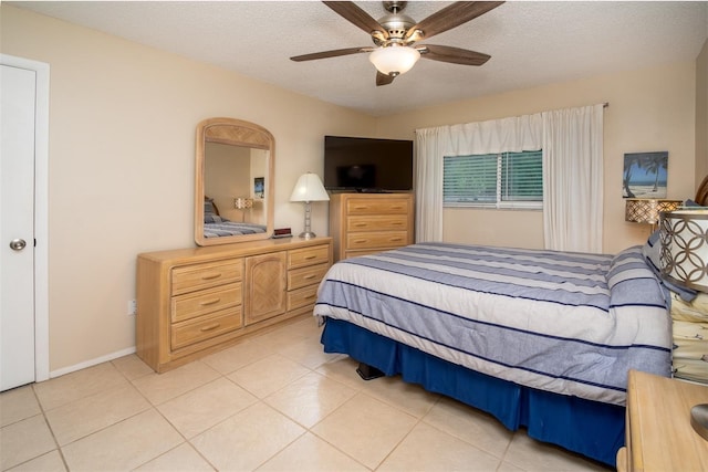 1701 Pinehurst Rd Unit 24B, Dunedin, FL 34698 - bedroom with light tile patterned floors, a textured ceiling, and ceiling fan