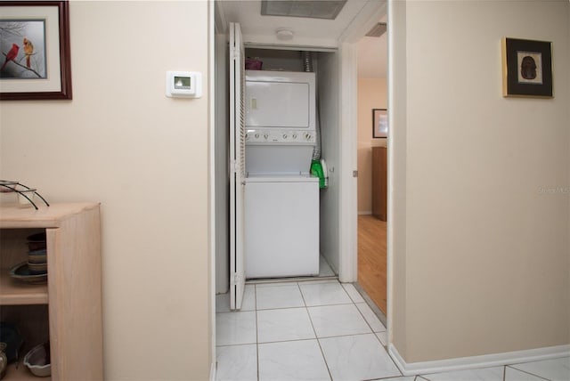 1701 Pinehurst Rd Unit 24B, Dunedin, FL 34698 - laundry area featuring estacked washer and dryer and baseboards