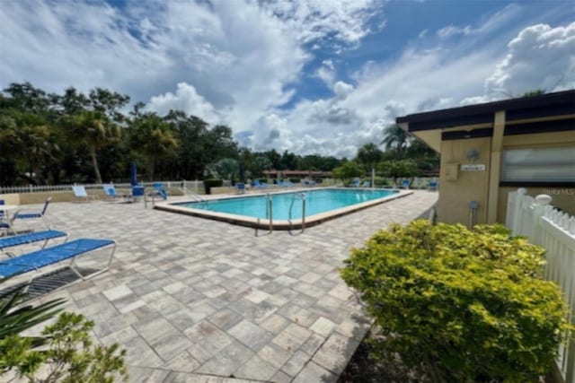 1701 Pinehurst Rd Unit 24B, Dunedin, FL 34698 - community pool with a patio area and view of wooded area
