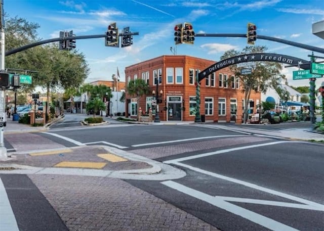 1701 Pinehurst Rd Unit 24B, Dunedin, FL 34698 - view of asphalt street with traffic lights, sidewalks, curbs, street lights, and traffic signs