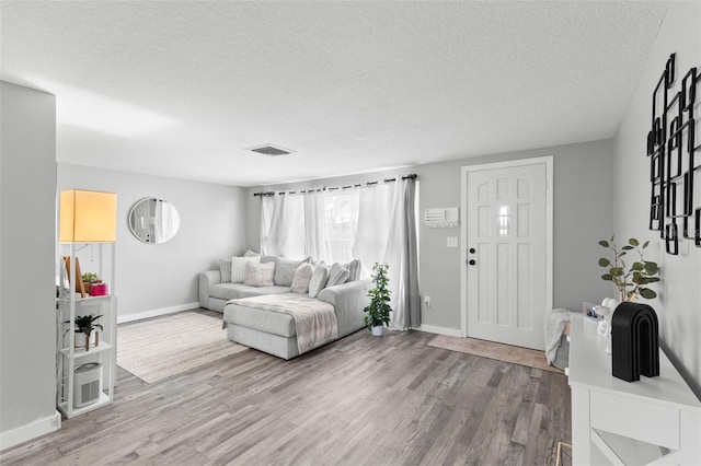 8004 Beaver Creek Loop, Hudson, FL 34667 - living area featuring wood finished floors and a textured ceiling