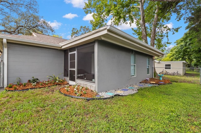 8004 Beaver Creek Loop, Hudson, FL 34667 - view of home's exterior featuring a sunroom and a shingled roof