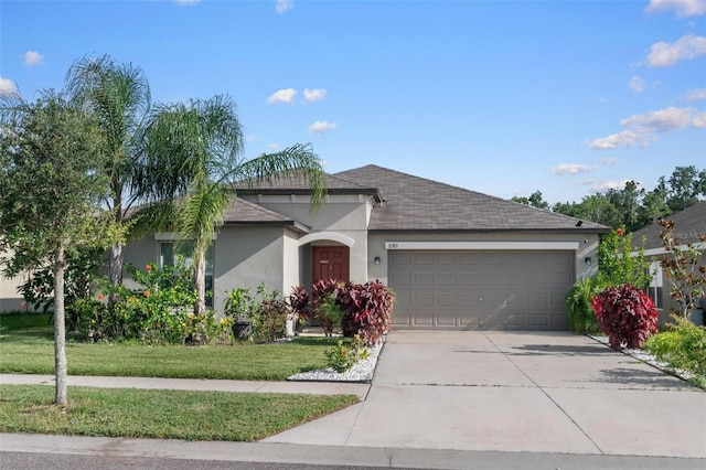 11303 Misty Moss Dr, Wimauma, FL 33598 - view of front of property featuring stucco siding, a garage, concrete driveway, a front yard, and a shingled roof