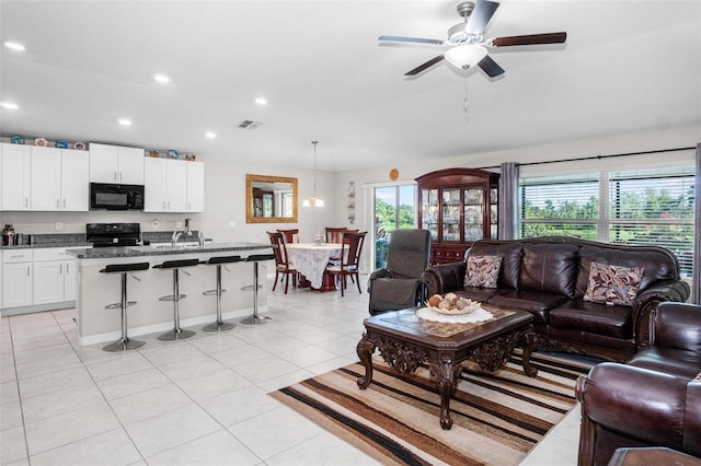 11303 Misty Moss Dr, Wimauma, FL 33598 - living room featuring light tile patterned floors, recessed lighting, and ceiling fan